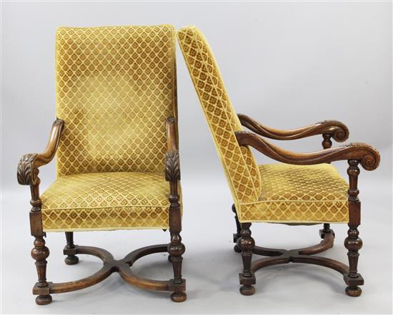 A pair of Flemish style foliate carved oak armchairs,